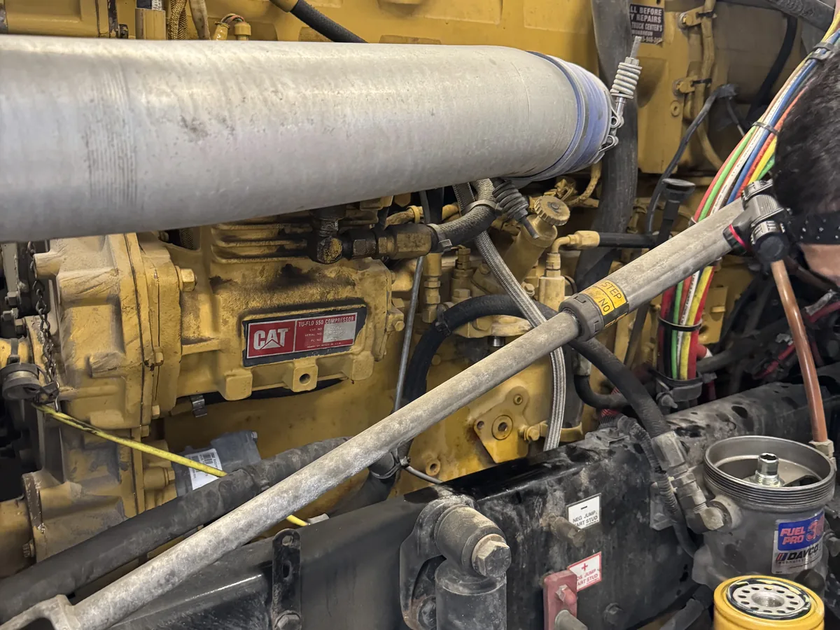 Caterpillar diesel engine with charge air piping running across the top