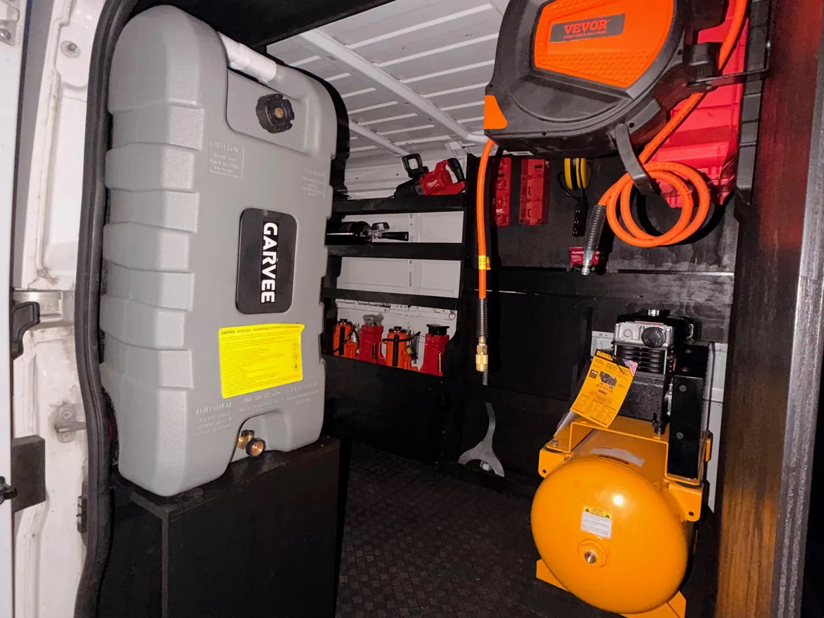 Air tank, compressor and fluid containers mounted inside a service van