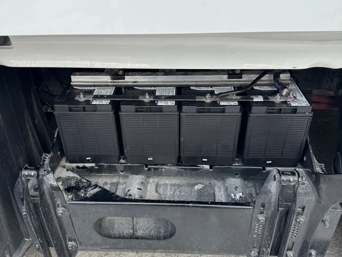 Row of batteries seated in a battery tray with the cover removed