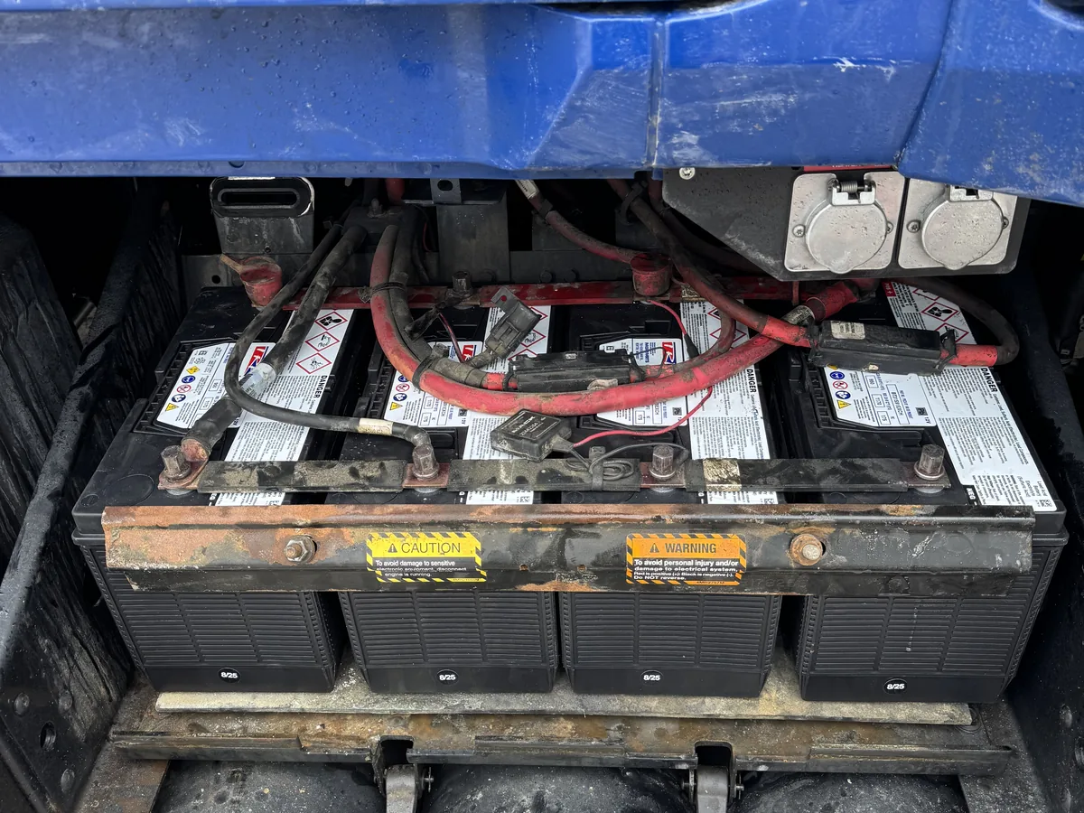 New batteries installed and strapped down in a semi truck battery box